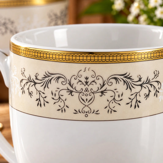 Close-up of the baroque scroll design and gold rim on the porcelain cup