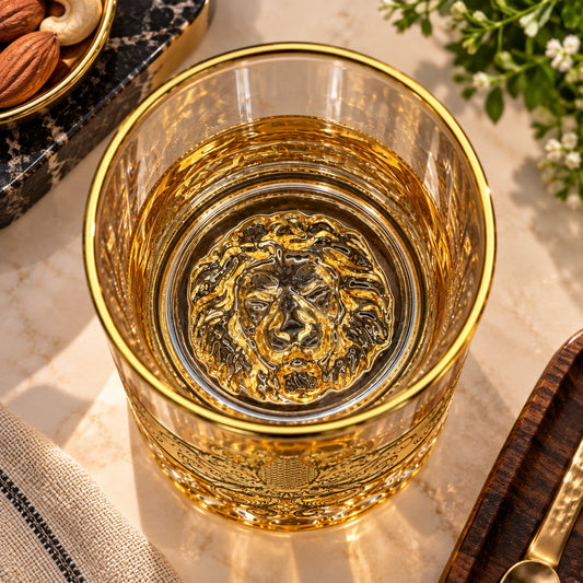 Close-up of the sculpted lion face inside the base of the drinking glass