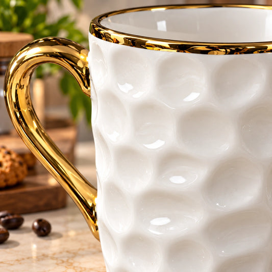 Close-up of the dimple texture and gold rim on the ceramic mug